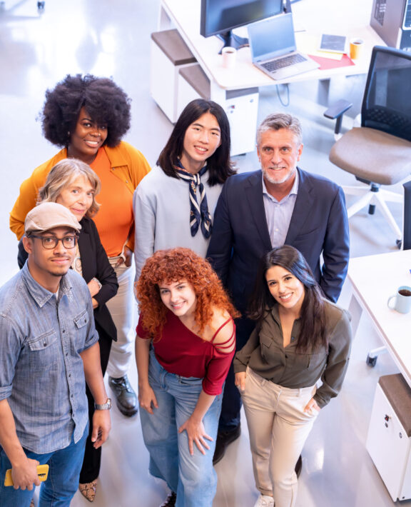 Diverse business team smiling while posing together in the office. Diverse business team smiling while posing together in the office. Business concept.